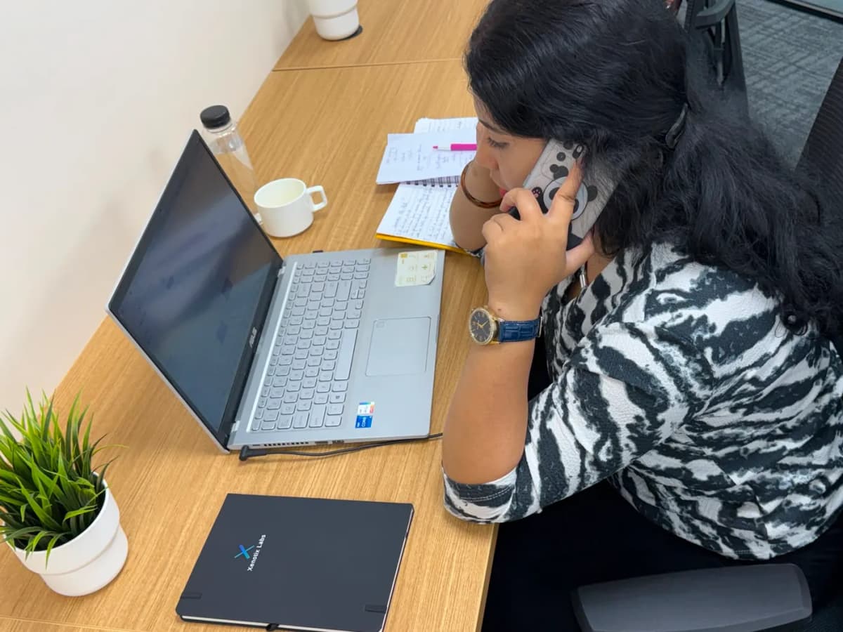 A team member on a client call at her desk